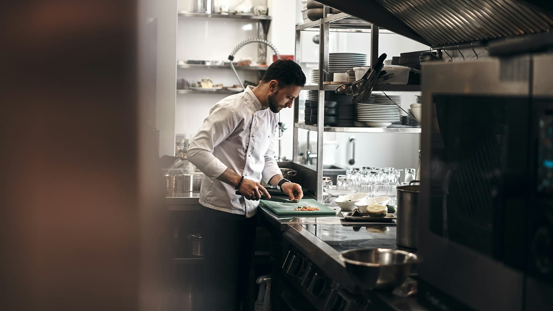 Chef preparing ingredients in a professional restaurant kitchen