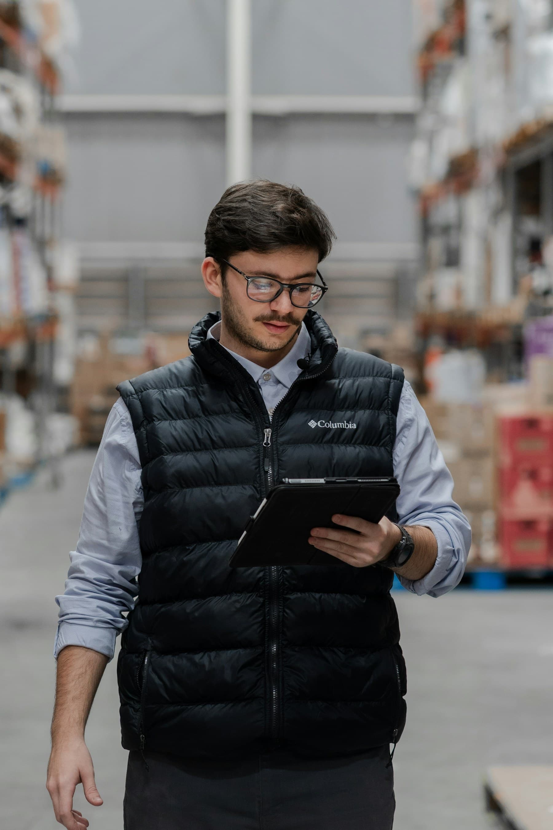Warehouse manager reviewing supplier order details on a tablet
